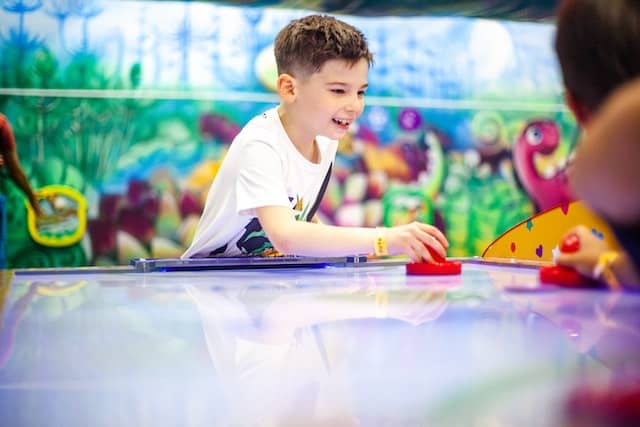 Boy in a White Shirt Playing Table Hockey